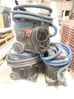 a pile of vacuums and other equipment sitting on a table