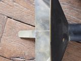 a knife that is laying on a wooden table
