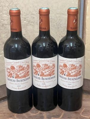 three bottles of wine sitting on top of a wooden table