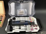 a box with a drill, screwdriver, and other tools in it