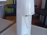 a white water dispenser on a counter in a kitchen
