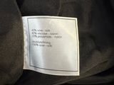 a label on a black jacket with a white label on it