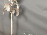 a glass table with a lamp and a palm tree on it