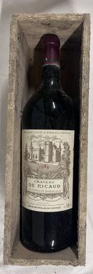 a bottle of wine in a wooden box on a table