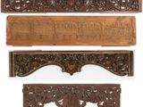 four carved wooden plaques of various sizes and shapes