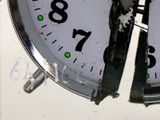 a close up of a clock with green numbers on it