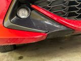 a close up of the front bumper of a red sports car