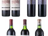 several bottles of wine are lined up on a white surface