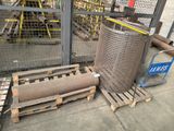 many rolls of metal on pallets in a warehouse