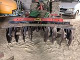 a tractor with a plow attached to it in the dirt