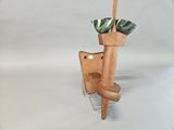 a vase that has a plant in it on a stand