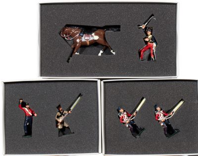 four miniature figurines of a horse and a man in uniform