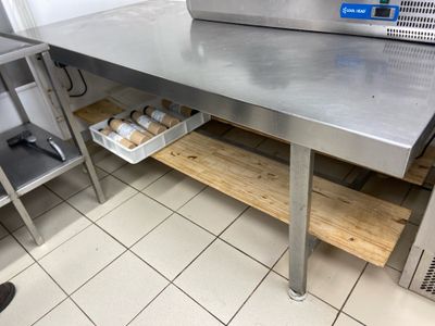 a large stainless steel table with two trays of food on it