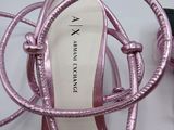 a pair of pink shoes that are on a table