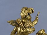 a gold statue of a man riding a horse with a bird on its back