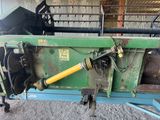 a close up of a green machine with a yellow handle in a building