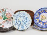 several plates are lined up on top of each other on a white surface