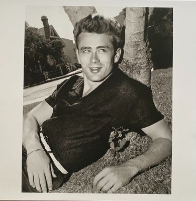 a black and white photo of a man with a teddy bear