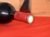 a bottle of wine on a table with a red cloth