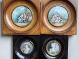 two framed pictures of a couple of people sitting on top of a table