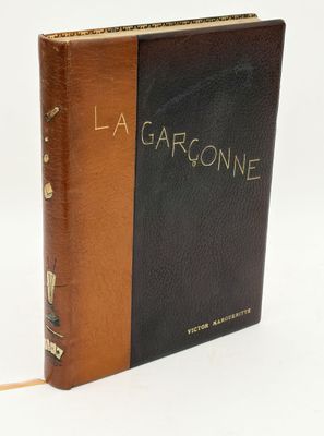 a brown and black book sitting on top of a white table