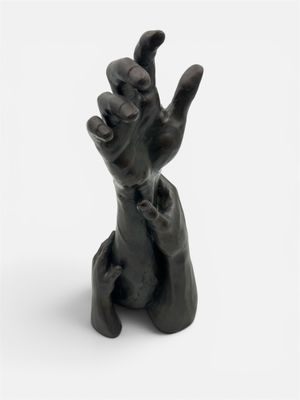 a black statue of a hand holding up a finger
