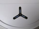 a close up of a white toilet with a black sticker on it