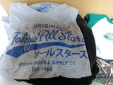 a pile of t - shirts and other items on a table