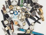 many different types of watches on a white surface