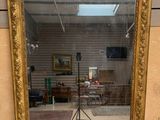 a mirror that is sitting on the floor in a room