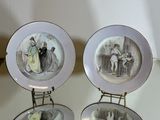 two plates with pictures of people on them sitting on a table