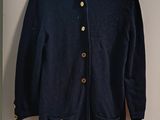 navy blue cardigan sweater with gold buttons hanging on a hanger