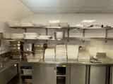 many plates and pans on the counter in the kitchen