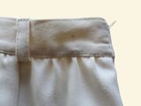 a close up of a pair of white pants with a white belt