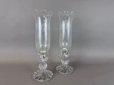 two clear glass vases sitting on top of a table