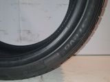 a close up of a tire on a white surface with a white wall in the background