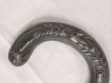 a close up of a horseshoe shaped object on a white surface