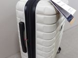 a white suitcase with a black handle sitting on the floor