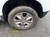 a white car with a flat tire on the street