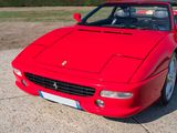 a red sports car parked on the side of the road