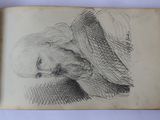 an old book with a drawing of a woman ' s face on it