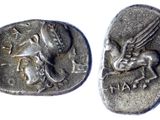two ancient silver coins with a dragon and a horse on them