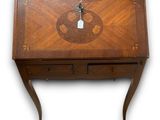 a small wooden desk with a clock on top of it