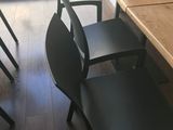 four chairs that are sitting in front of a table