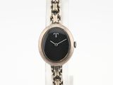 a close up of a wrist watch with a chain around it