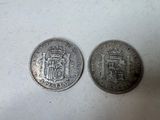 two silver coins with a coat of arms on them