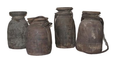 three brown vases are lined up on a white surface