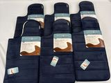 six blue oven mitts are lined up on a white surface