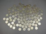 a pile of silver coins sitting on top of a table