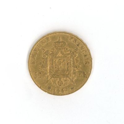 an old gold coin on a white surface with a white background